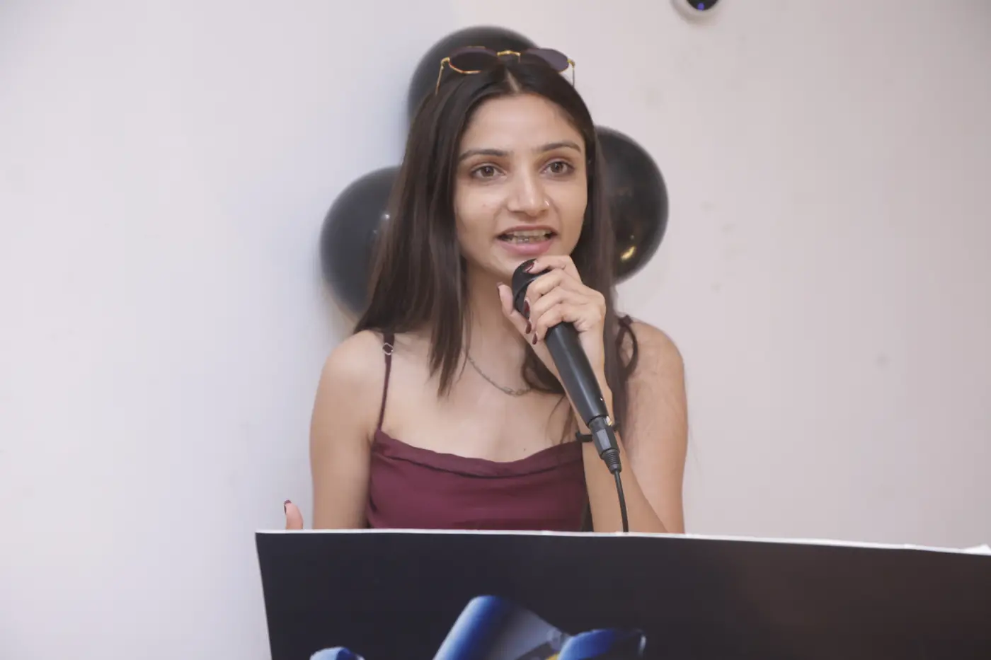 A guest speaking into a microphone during a family celebration