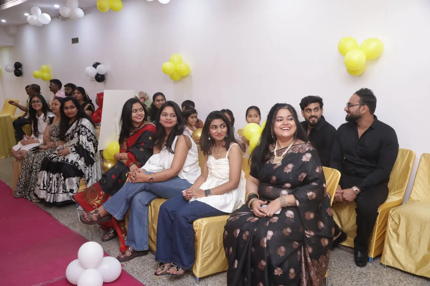 A row of guests seated together and smiling