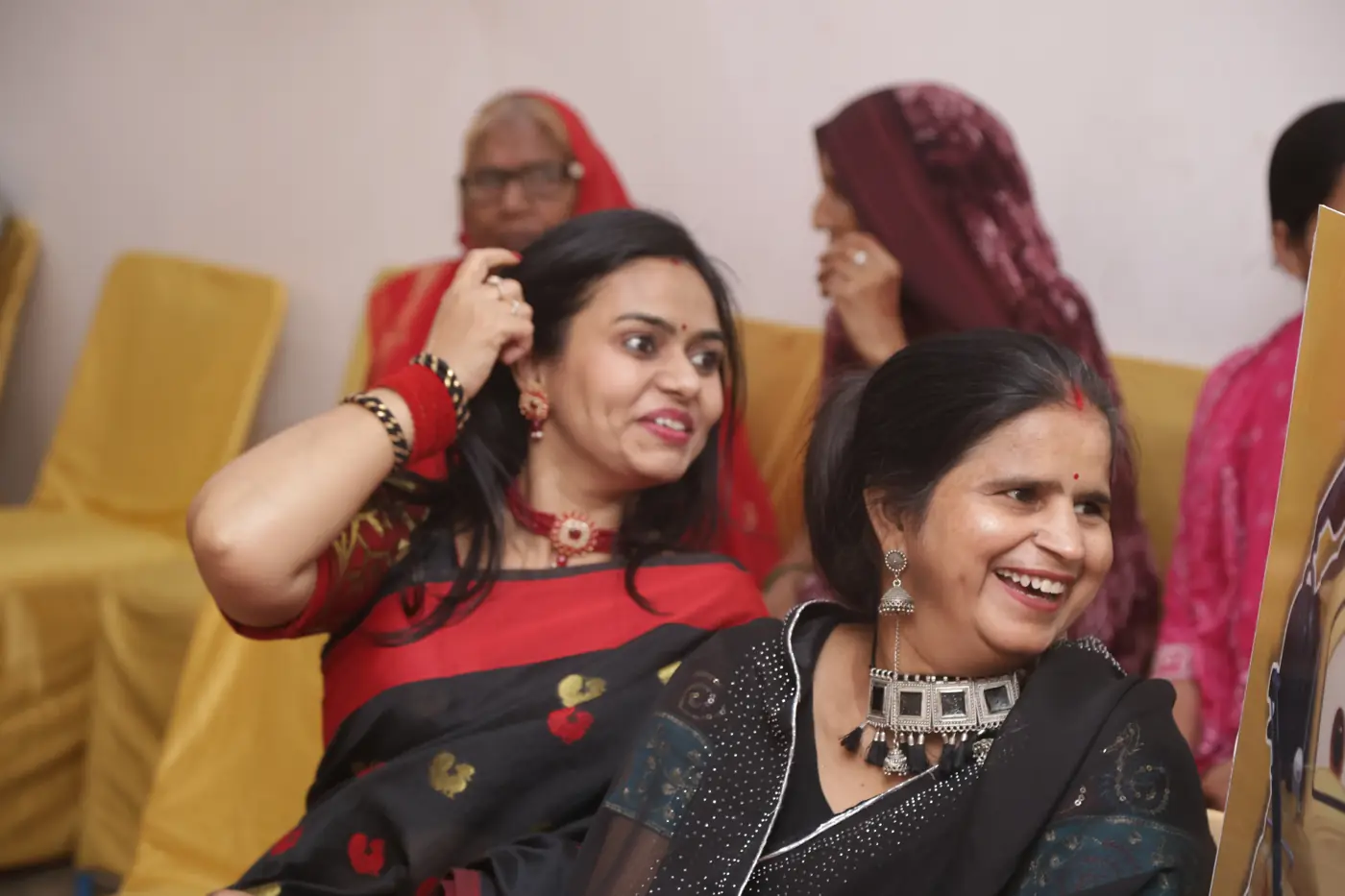 Two women laughing together during the celebration