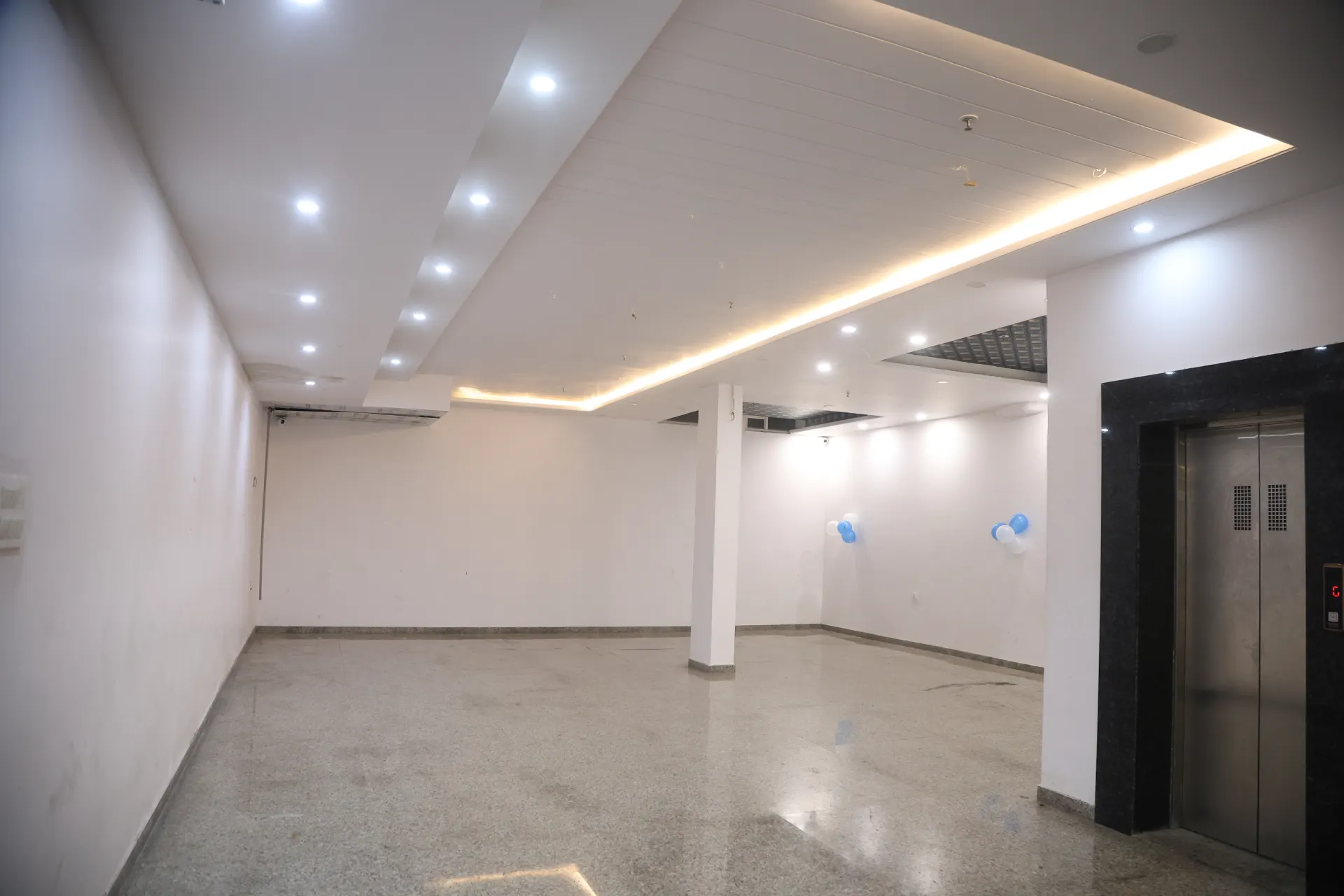 Empty banquet hall showing its white walls and polished floor