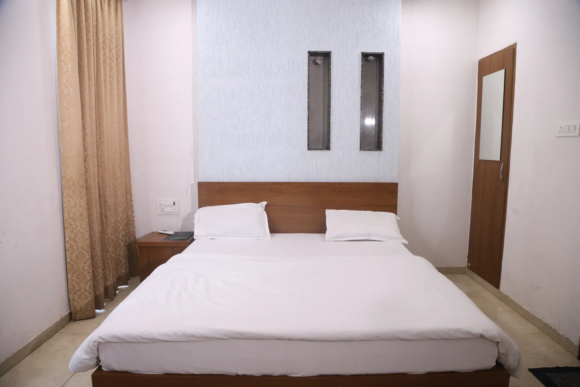 Guest room with a neatly made white bed