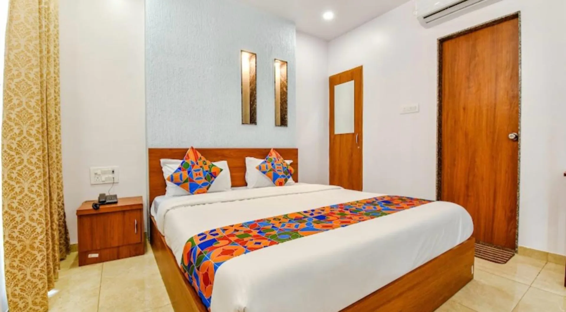 Guest room with a colourful bed runner
