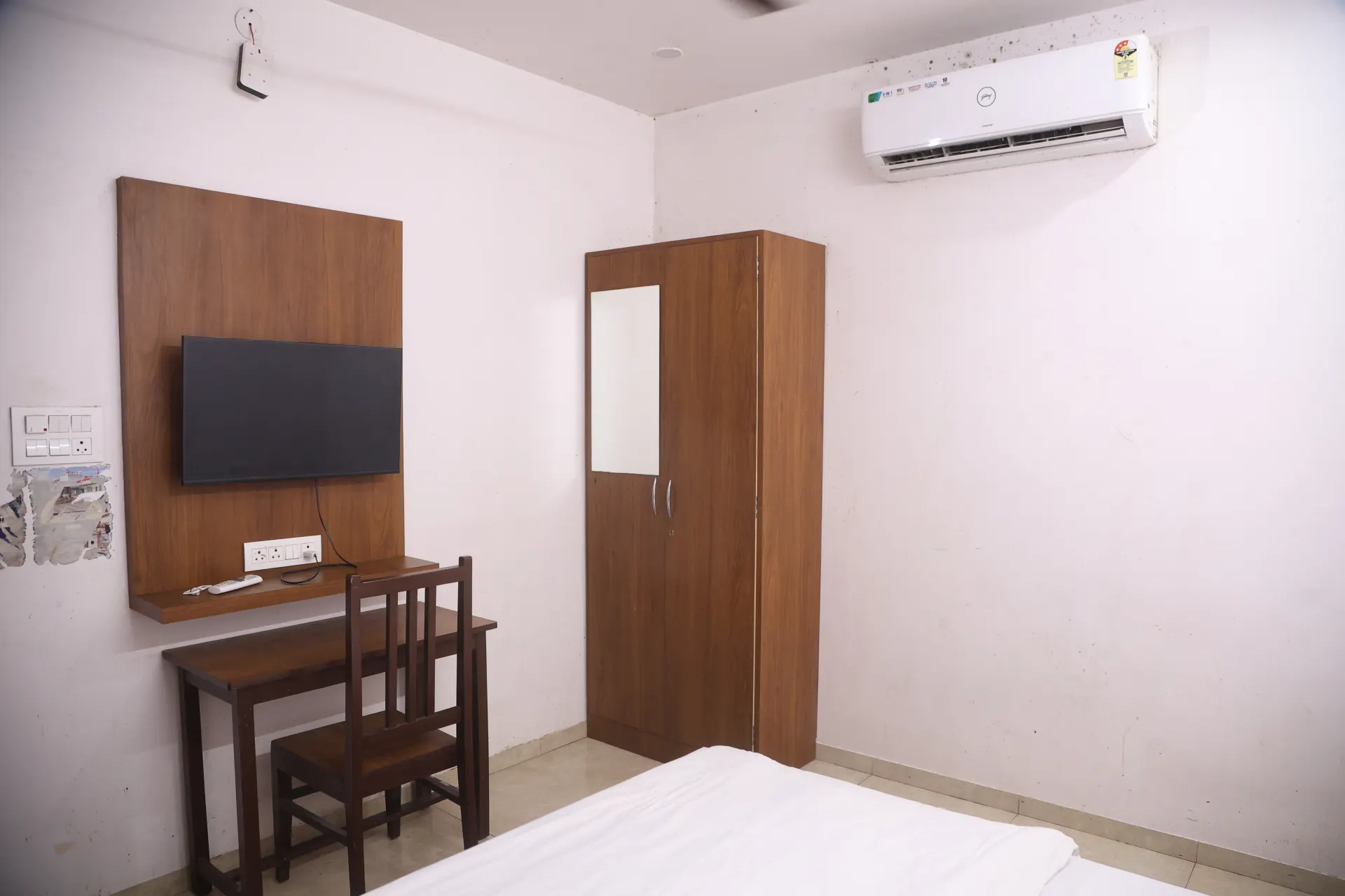 Room with a wall TV and desk